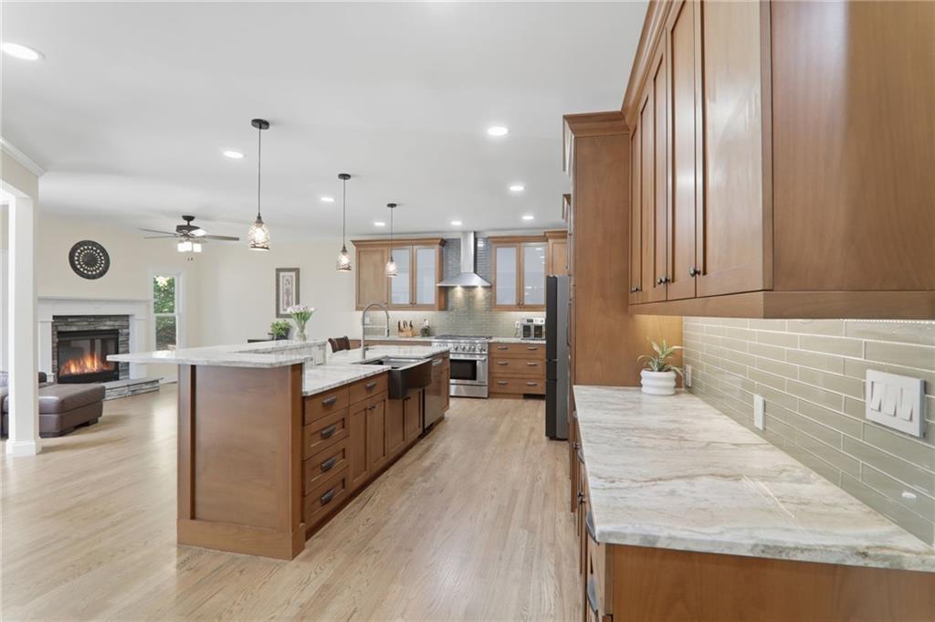 67 Pointer Lane Braselton, GA 30517 - Photo 29 of 74 a large kitchen with stainless steel appliances granite countertop a large counter top a stove and a wooden floors