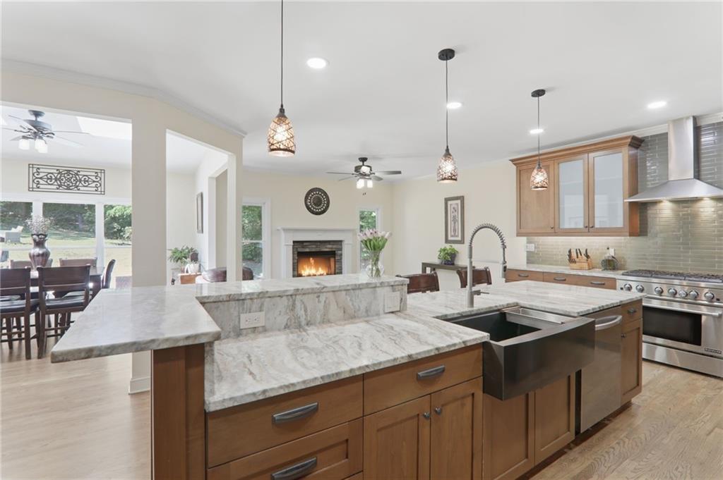 67 Pointer Lane Braselton, GA 30517 - Photo 4 of 74 a kitchen with stainless steel appliances granite countertop a sink a stove and a wooden floors