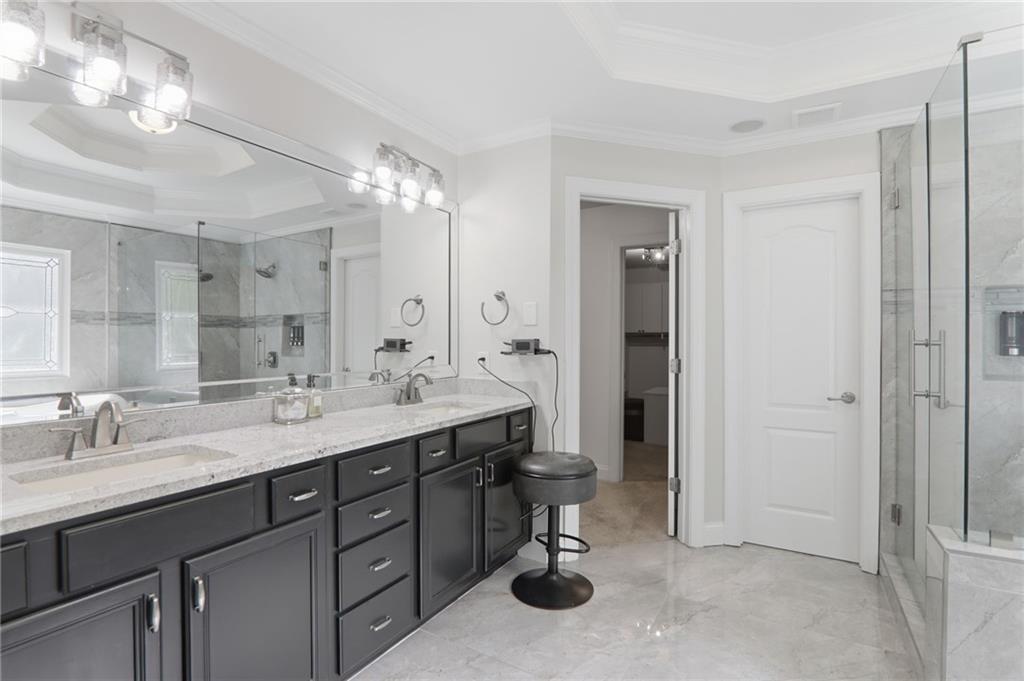 67 Pointer Lane Braselton, GA 30517 - Photo 41 of 74 a bathroom with a sink double vanity and a mirror