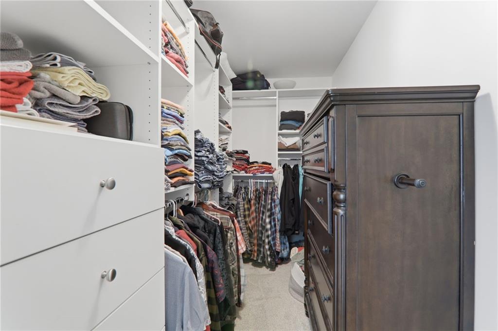 67 Pointer Lane Braselton, GA 30517 - Photo 45 of 74 a view of walk in closet with clothes and shoes
