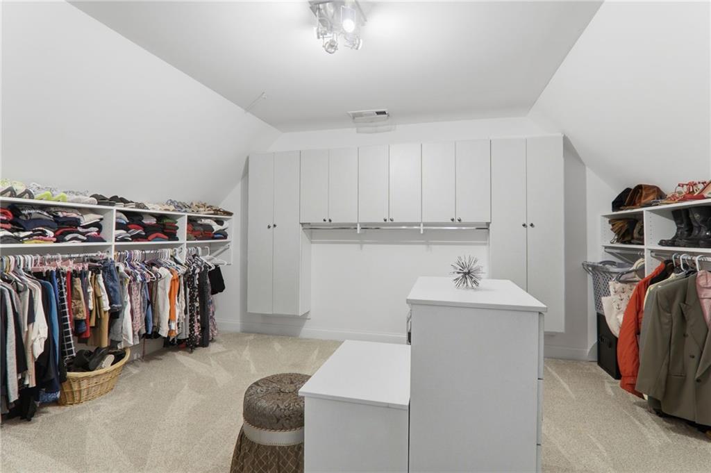 67 Pointer Lane Braselton, GA 30517 - Photo 46 of 74 a view of walk in closet with clothes and shoes