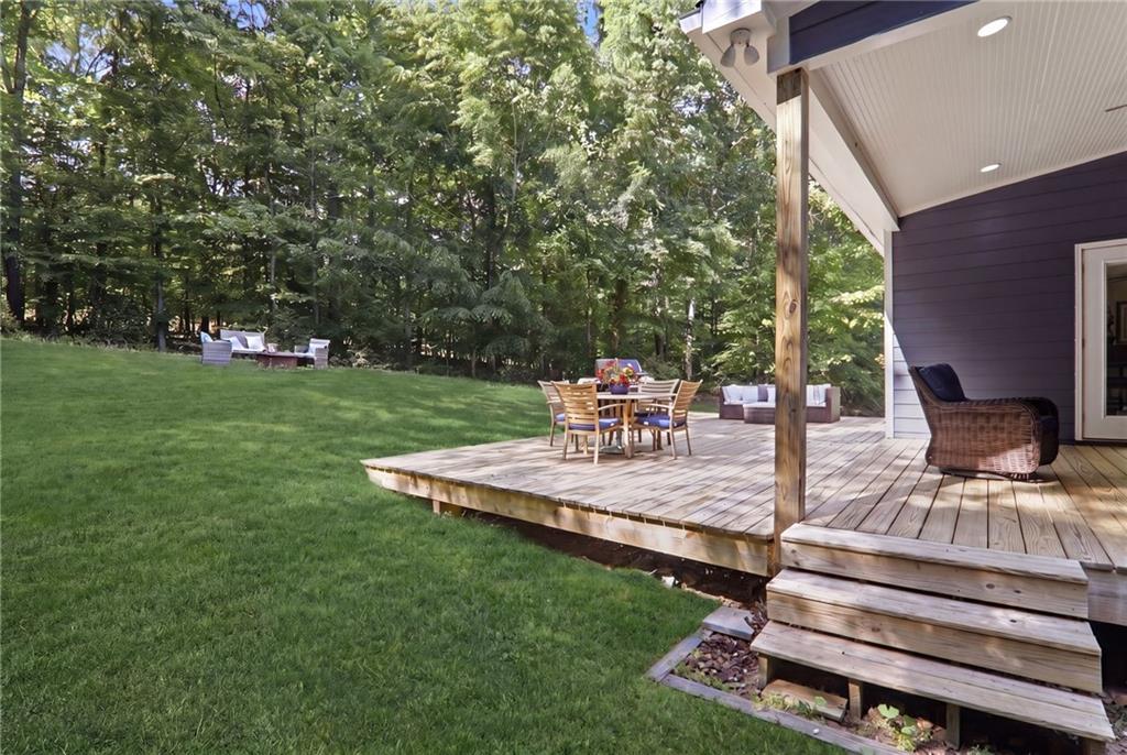 67 Pointer Lane Braselton, GA 30517 - Photo 59 of 74 a view of a backyard with lawn chairs potted plants and large tree