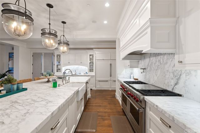 a spacious bedroom with a bed and a chandelier