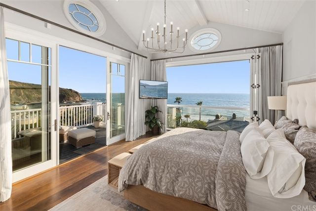 a projector room with large couches kitchen view dining table and chairs