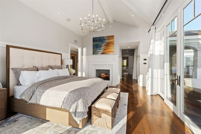 a living room with furniture a chandelier and a large window