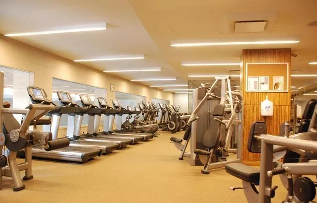 a bathroom with a tub a sink and mirrors