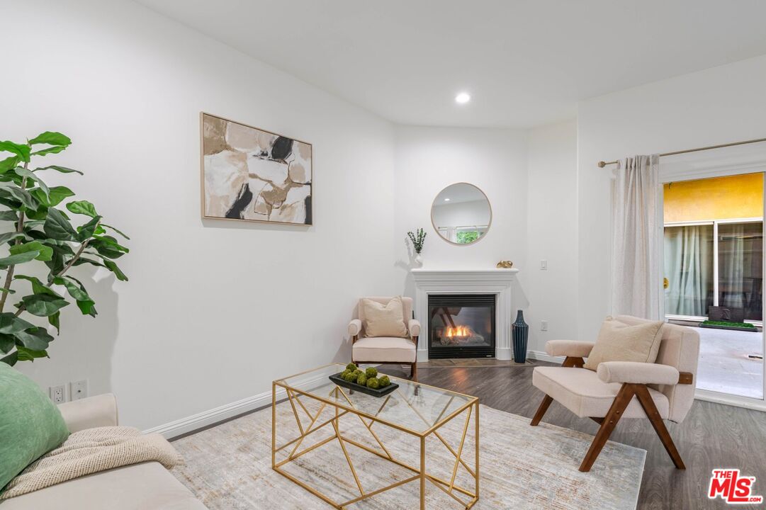5521 Kester Avenue, Unit 7 Sherman Oaks, CA 91411 - Photo 1 of 45 a living room with furniture and a fireplace