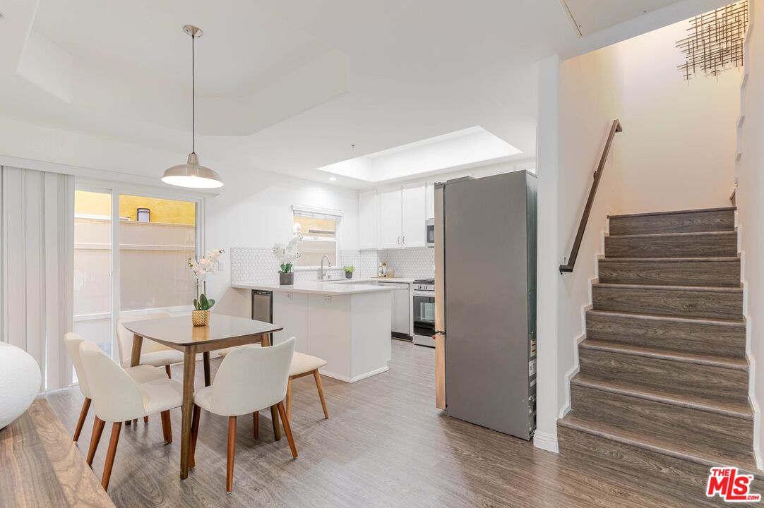 5521 Kester Avenue, Unit 7 Sherman Oaks, CA 91411 - Photo 13 of 45 a dining room with furniture and wooden floor
