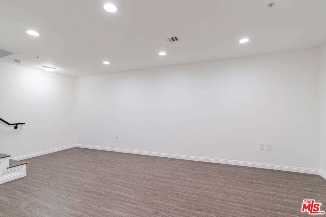 5521 Kester Avenue, Unit 7 Sherman Oaks, CA 91411 - Photo 16 of 45 an empty room with wooden floor and natural light