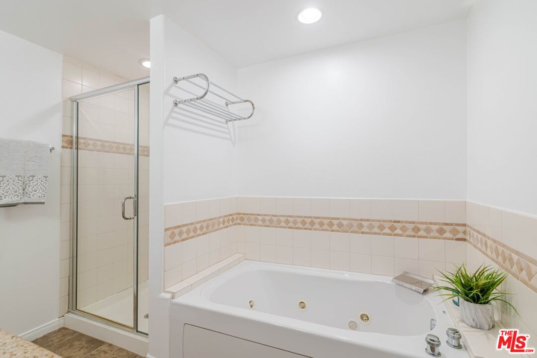 5521 Kester Avenue, Unit 7 Sherman Oaks, CA 91411 - Photo 29 of 45 a bathroom with a bathtub and a shower