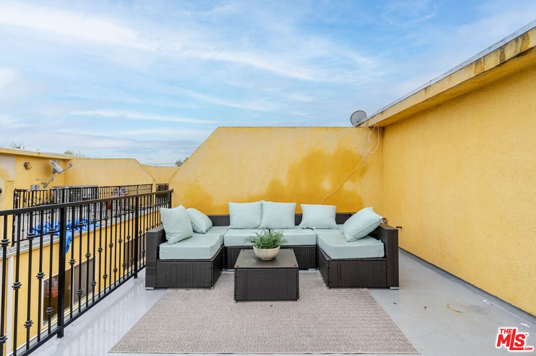 5521 Kester Avenue, Unit 7 Sherman Oaks, CA 91411 - Photo 36 of 45 a balcony with furniture and wooden floor