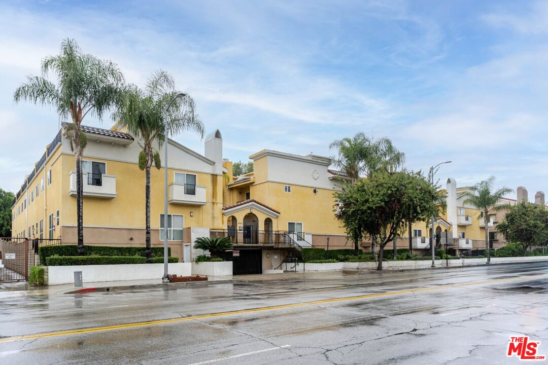 5521 Kester Avenue, Unit 7 Sherman Oaks, CA 91411 - Photo 45 of 45 a front view of a house with a yard and garage