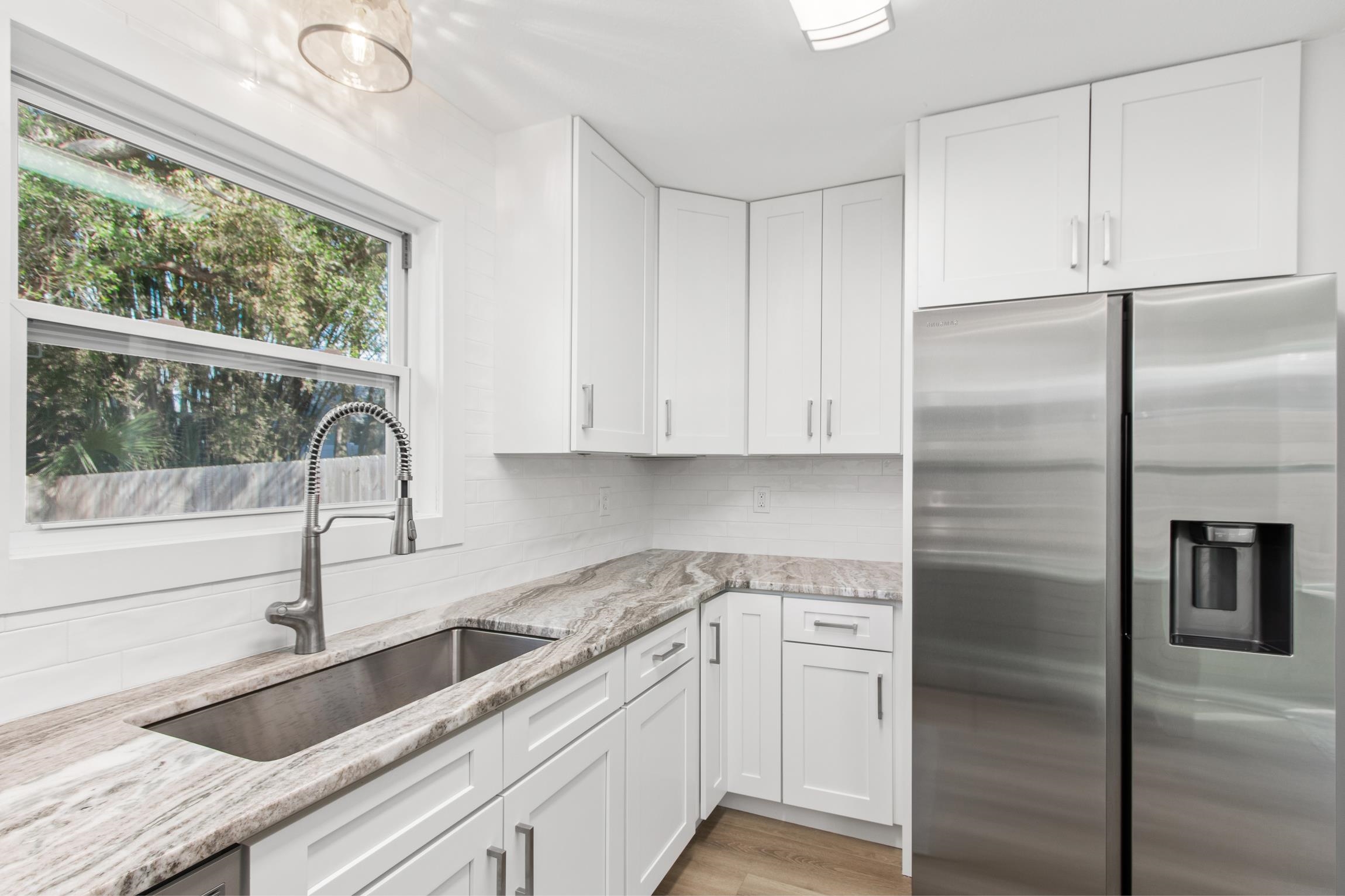 112 2nd Street, Unit A St. Augustine, FL 32080 - Photo 13 of 48 a kitchen with a refrigerator sink and cabinets