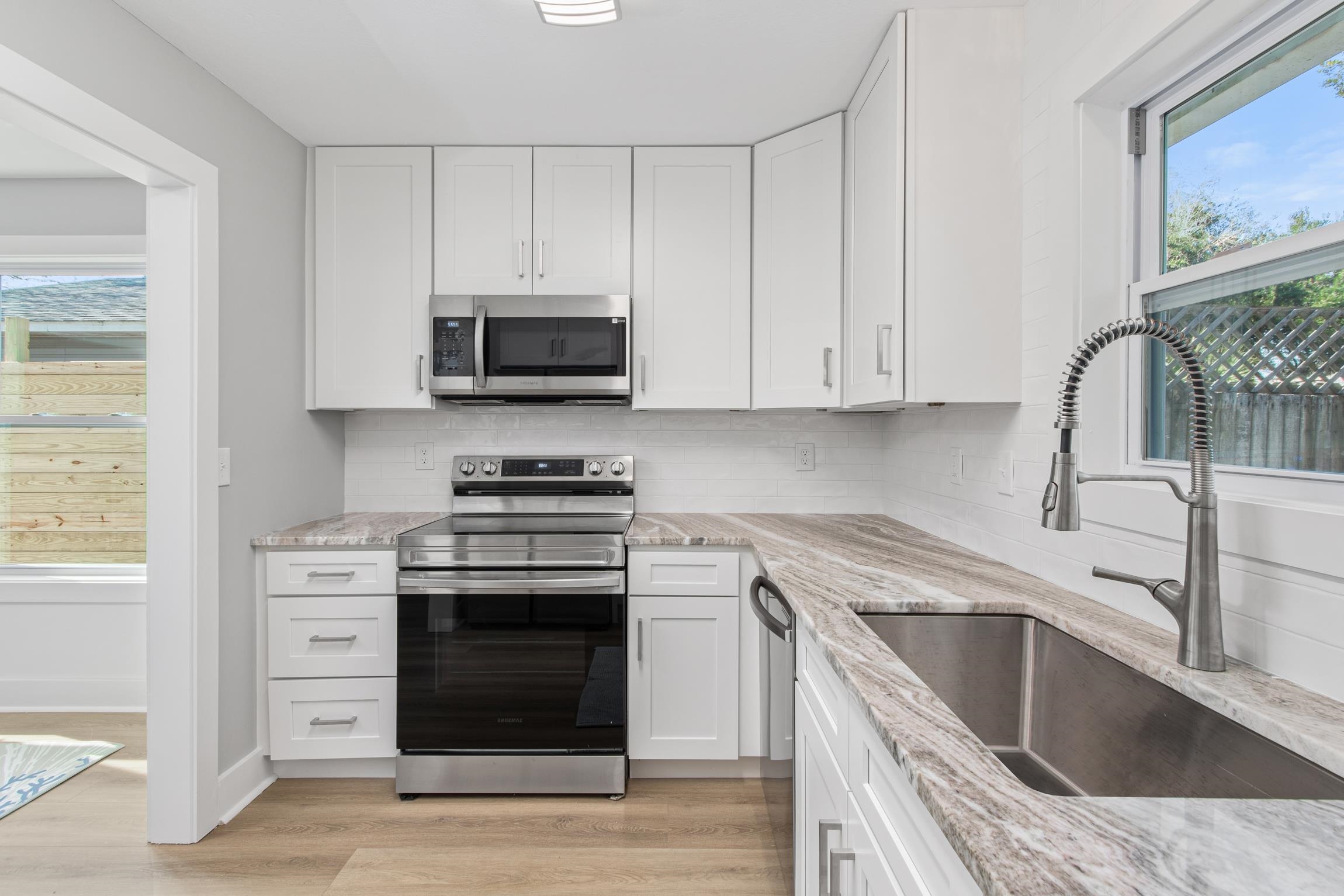 112 2nd Street, Unit A St. Augustine, FL 32080 - Photo 14 of 48 a kitchen with stainless steel appliances granite countertop a stove and a sink