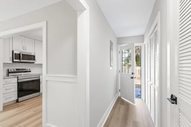 a view of a kitchen from a hallway