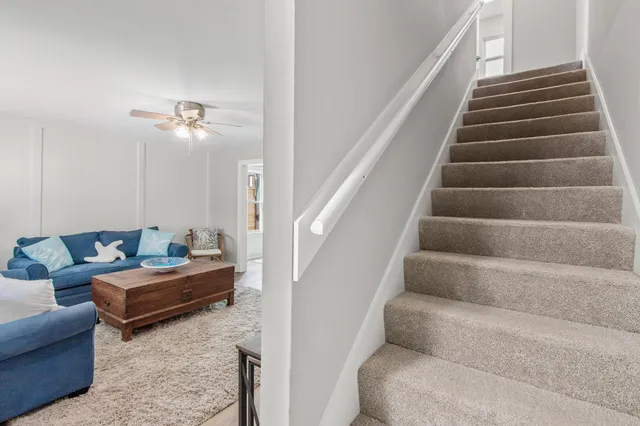 a living room with furniture and stairs