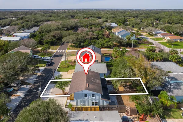 an aerial view of residential houses with outdoor space