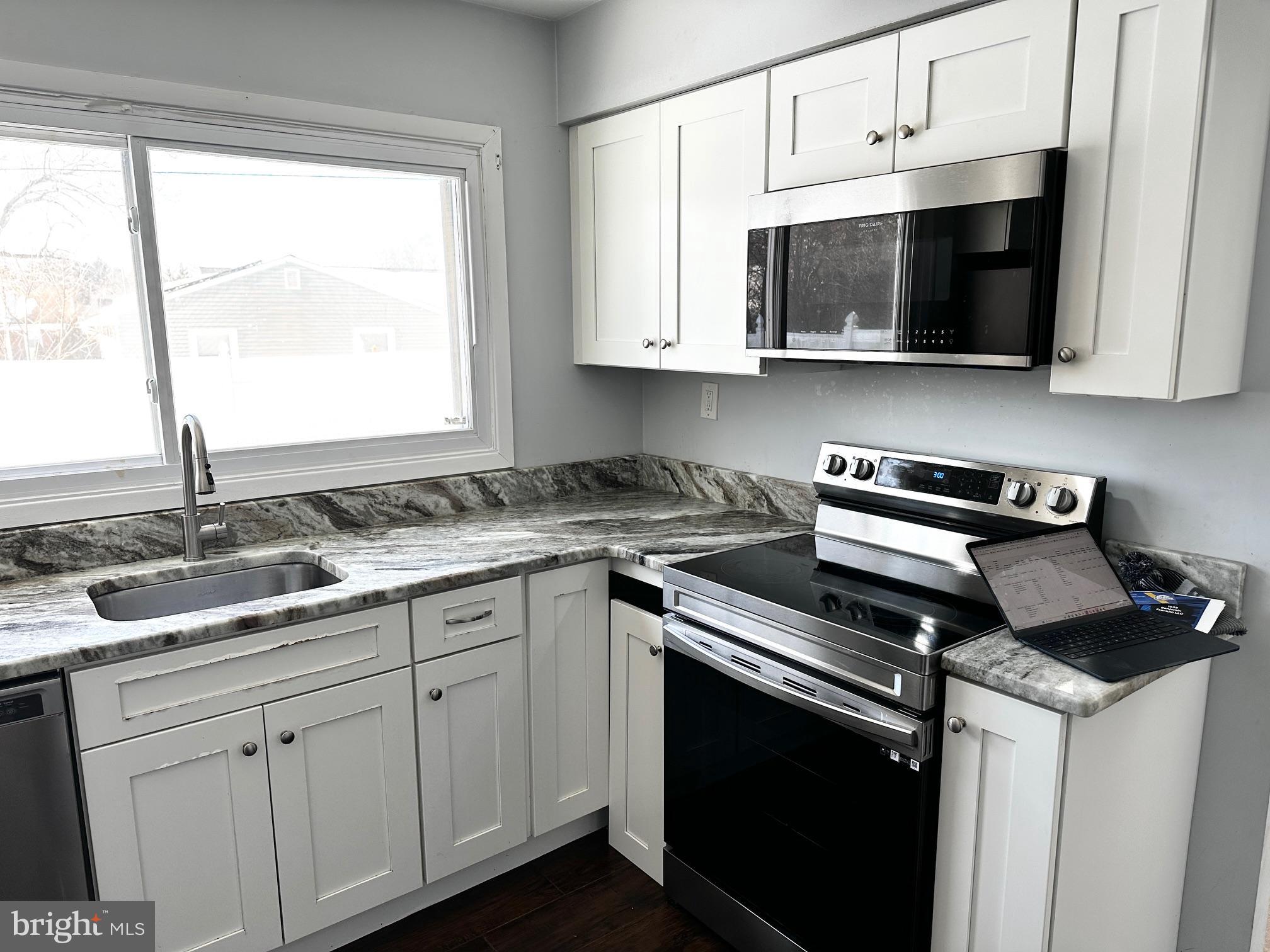 22 Gaylord Circle Willingboro, NJ 08046 - Photo 3 of 17 a kitchen with a sink stove and microwave