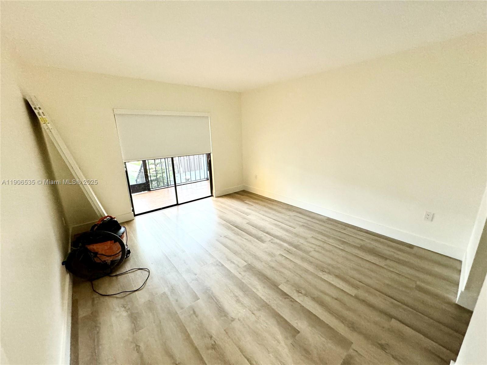 16401 Bridge End Road, Unit 16401 Miami Lakes, FL 33014 - Photo 11 of 19 a view of an empty room and wooden floor