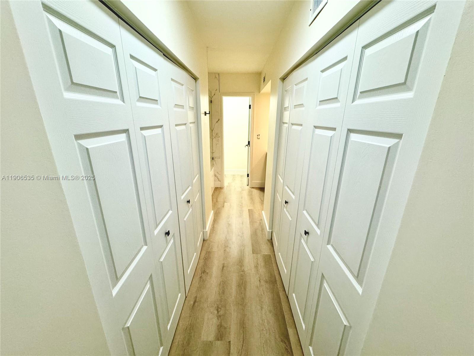 16401 Bridge End Road, Unit 16401 Miami Lakes, FL 33014 - Photo 12 of 19 a view of a hallway with wooden floor and staircase