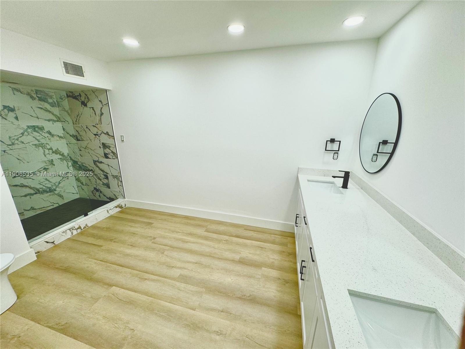 16401 Bridge End Road, Unit 16401 Miami Lakes, FL 33014 - Photo 15 of 19 a bathroom with a sink and a shower