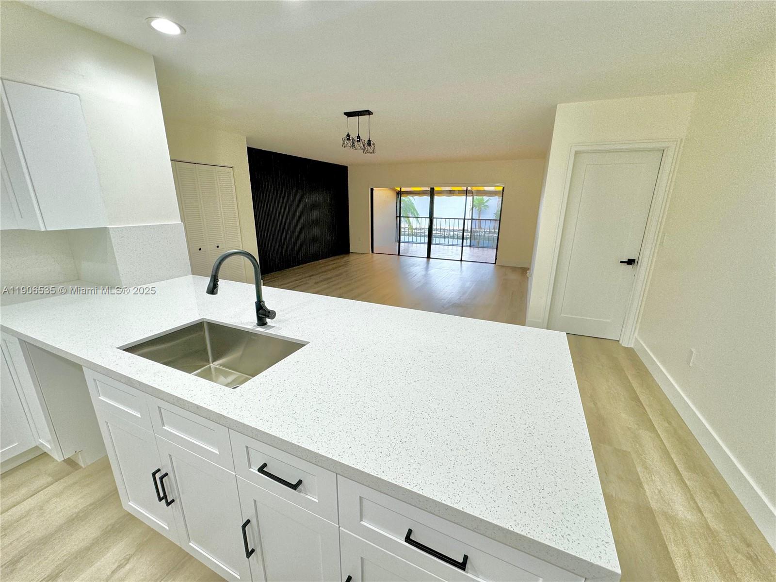 16401 Bridge End Road, Unit 16401 Miami Lakes, FL 33014 - Photo 7 of 19 a kitchen with a sink and cabinets