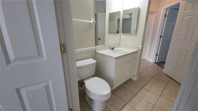 a white toilet sitting next to a bathroom sink
