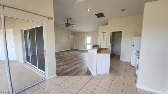 a view of a hallway with closet and a living room