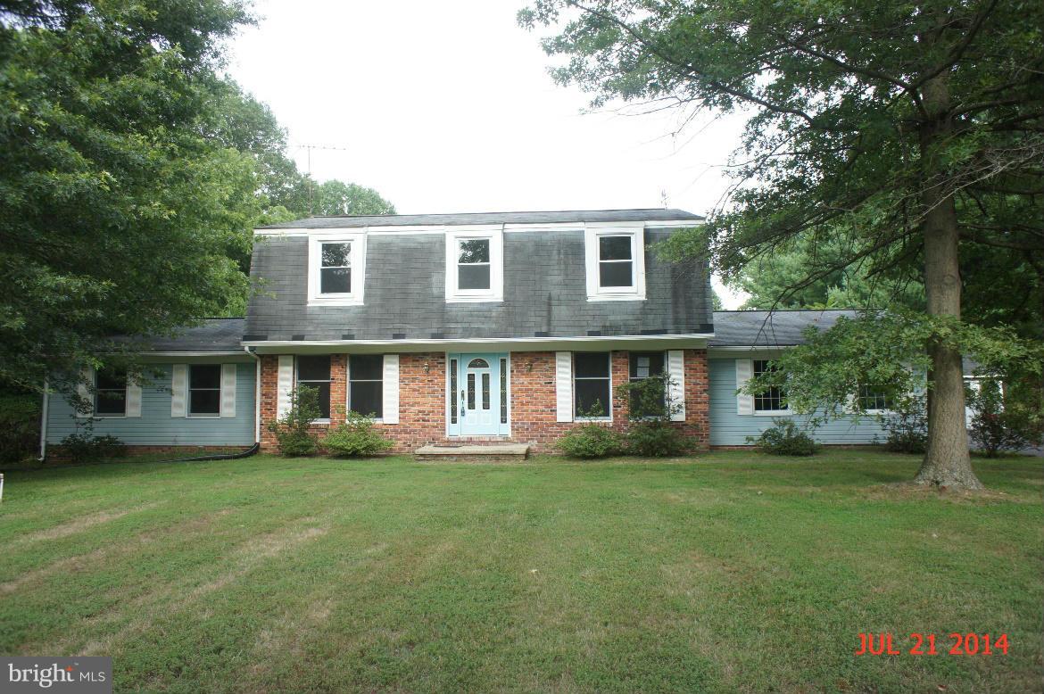 1821 Hatfield Road Huntingtown, MD 20639 - Photo 1 of 18 a front view of a house with a garden