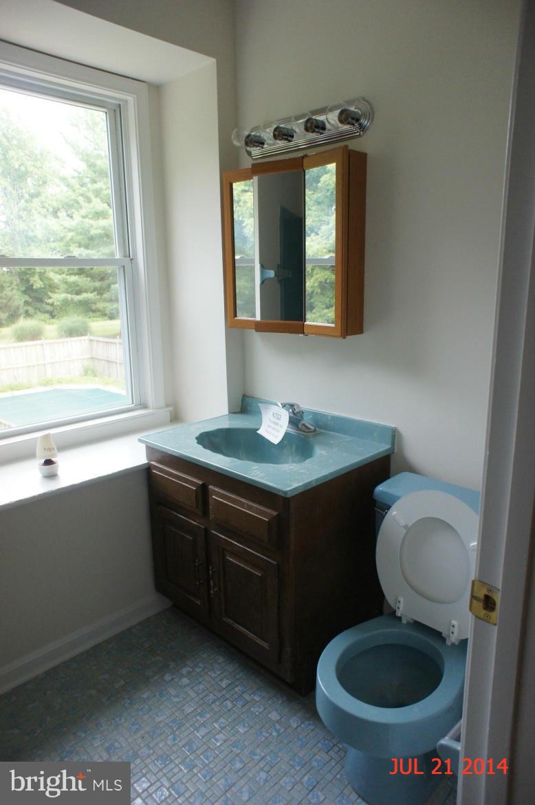 1821 Hatfield Road Huntingtown, MD 20639 - Photo 11 of 18 a bathroom with a toilet a sink and a window
