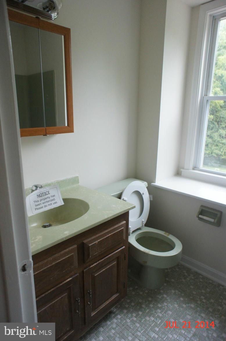 1821 Hatfield Road Huntingtown, MD 20639 - Photo 13 of 18 a bathroom with a granite countertop sink and a mirror