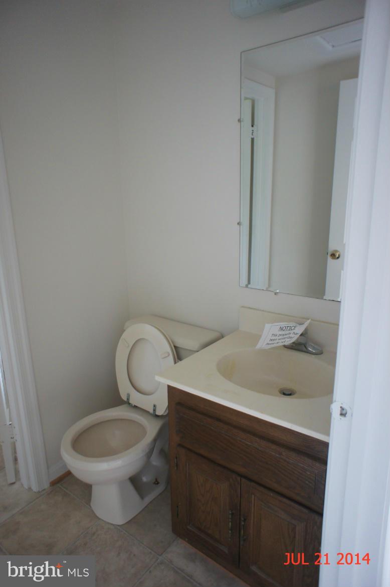 1821 Hatfield Road Huntingtown, MD 20639 - Photo 8 of 18 a bathroom with a toilet a sink and a mirror