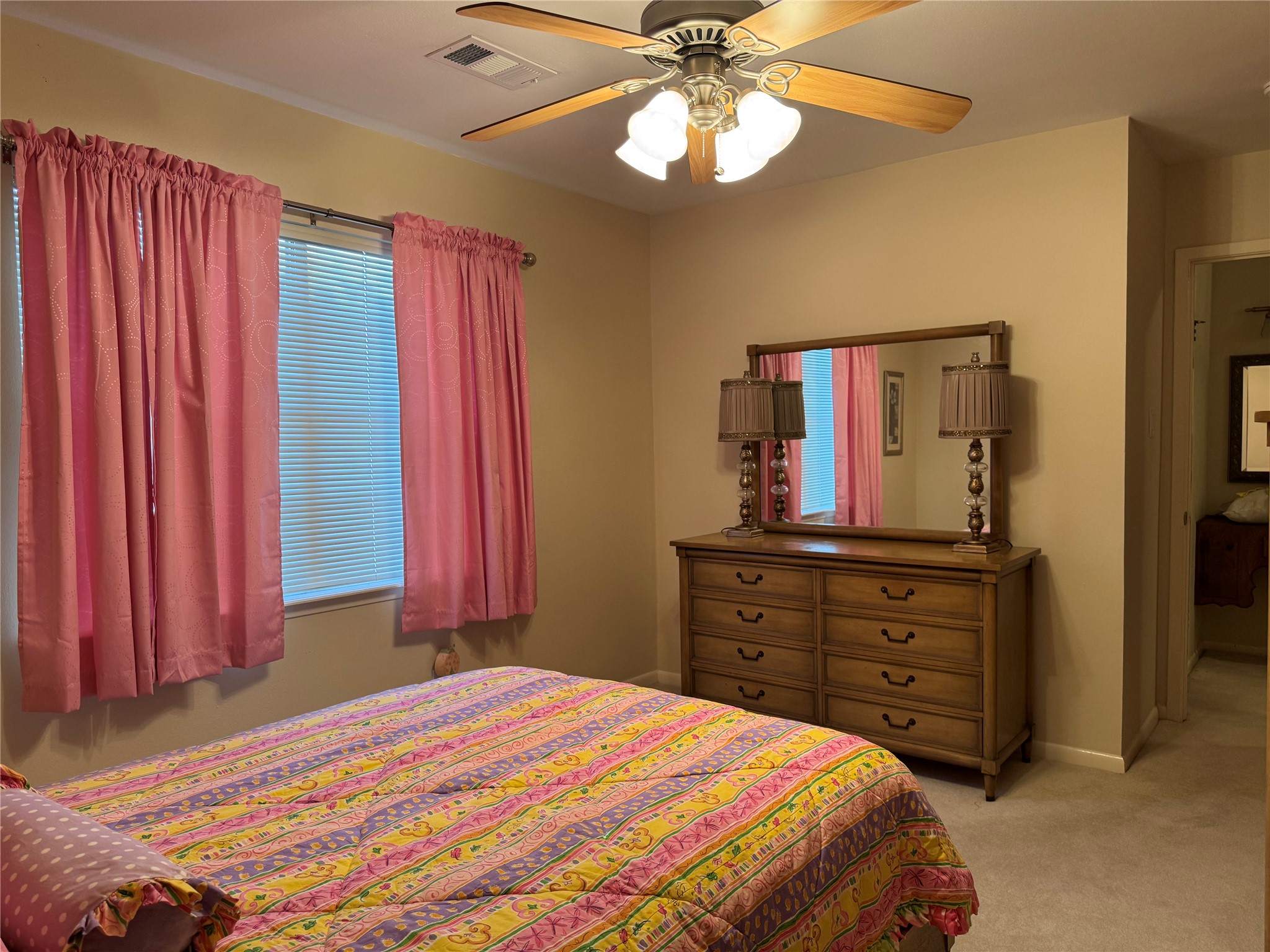 203 East Thornton Road Houston, TX 77022 - Photo 15 of 18 Another view of the second-floor bedroom with soft beige walls and a ceiling fan