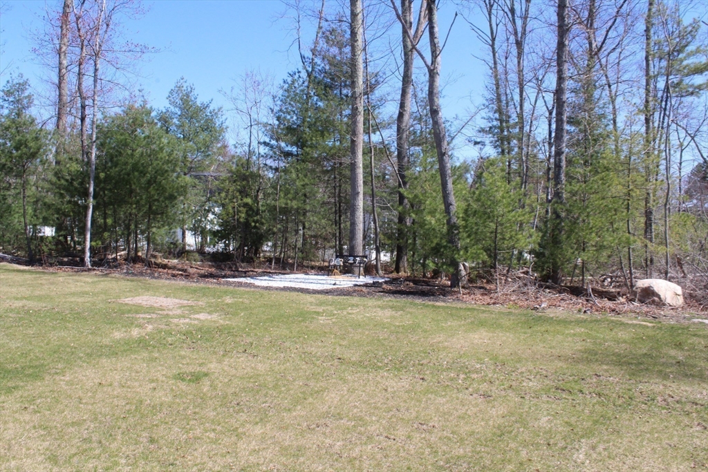 31 Lilac Avenue Bellingham, MA 02019 - Photo 37 of 40 a view of a swimming pool with lawn chairs under an umbrella