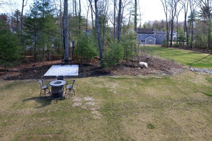 31 Lilac Avenue Bellingham, MA 02019 - Photo 40 of 40 a wooden bench sitting in the middle of a park