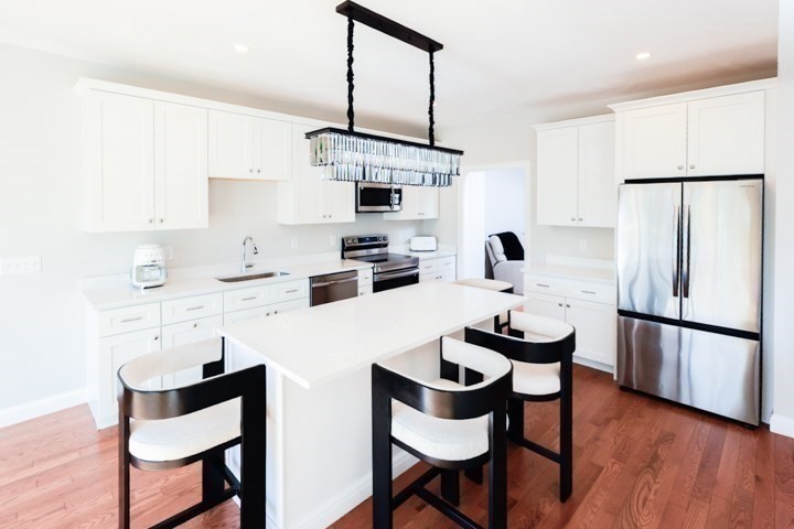 31 Lilac Avenue Bellingham, MA 02019 - Photo 6 of 40 a kitchen with stainless steel appliances a sink and a refrigerator