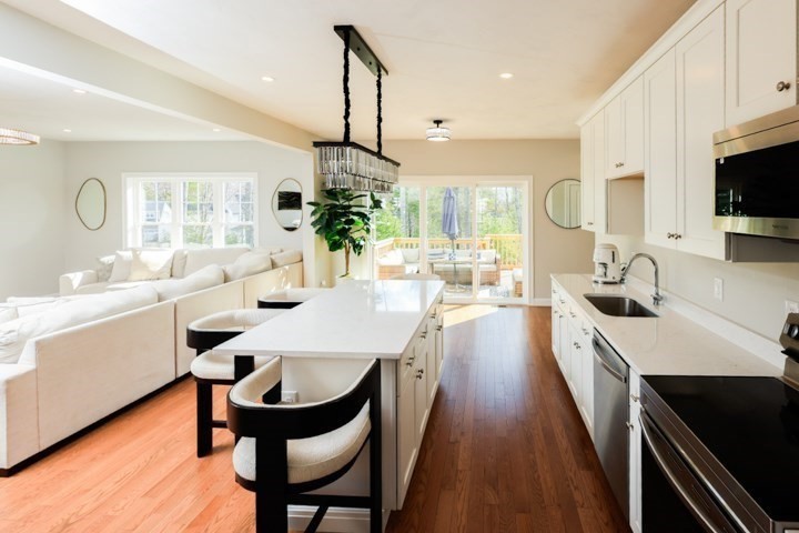 31 Lilac Avenue Bellingham, MA 02019 - Photo 8 of 40 a kitchen with sink a refrigerator and chairs