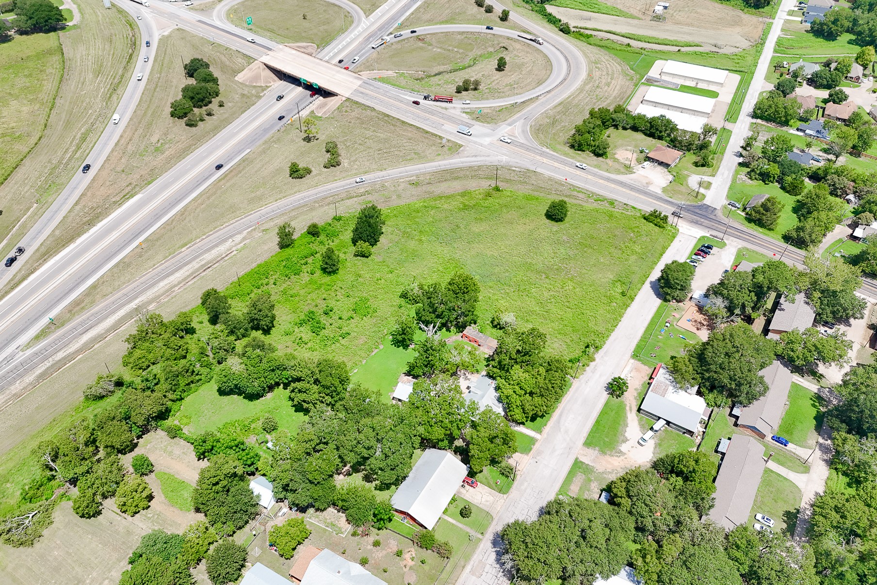 102 South Dixie Street Brenham, TX 77833 - Photo 24 of 40 an aerial view of a house with a yard and large trees