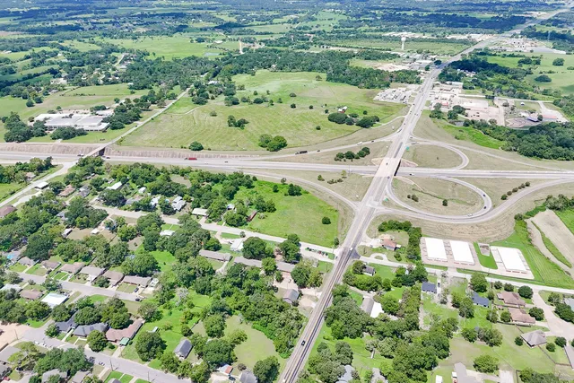 an aerial view of swimming pool with a yard and outdoor seating