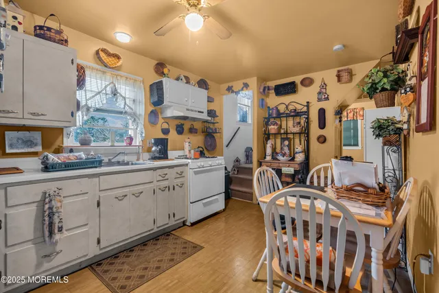 a kitchen with stainless steel appliances kitchen island granite countertop a table and chairs in it