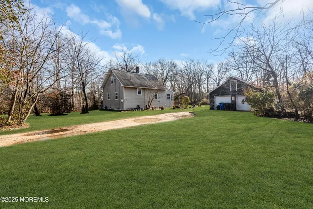 a front view of house with yard and green space
