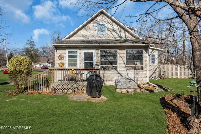 a view of a house with a backyard porch and sitting area