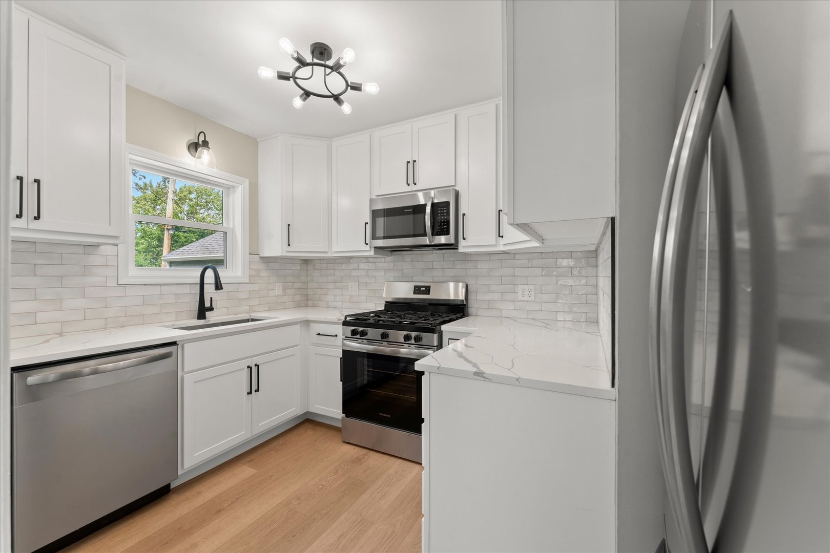 305 South Fair Street Champaign, IL 61821 - Photo 12 of 41 a kitchen with stainless steel appliances a sink stove and refrigerator