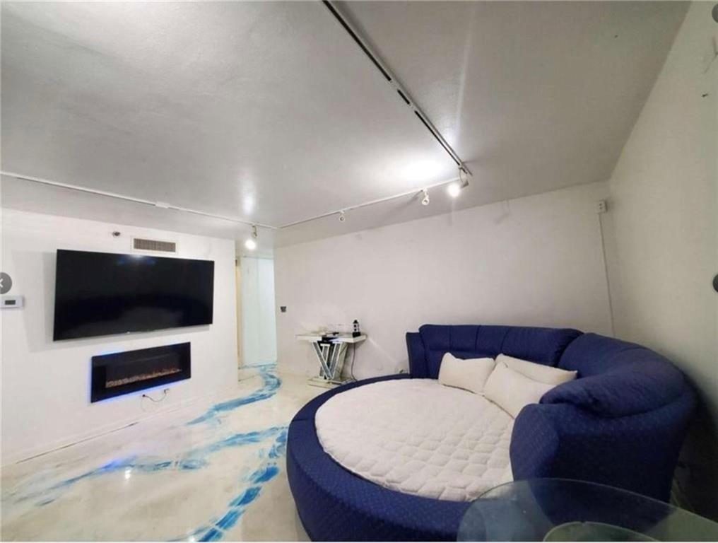 620 Peachtree Street Northeast, Unit 901 Atlanta, GA 30308 - Photo 12 of 19 a living room with furniture and a flat screen tv