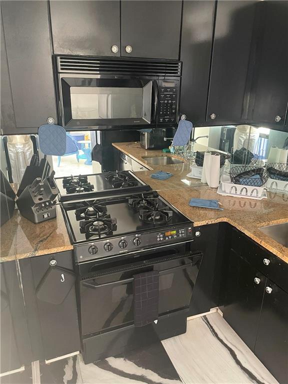 620 Peachtree Street Northeast, Unit 901 Atlanta, GA 30308 - Photo 13 of 19 a kitchen with a stove and a sink