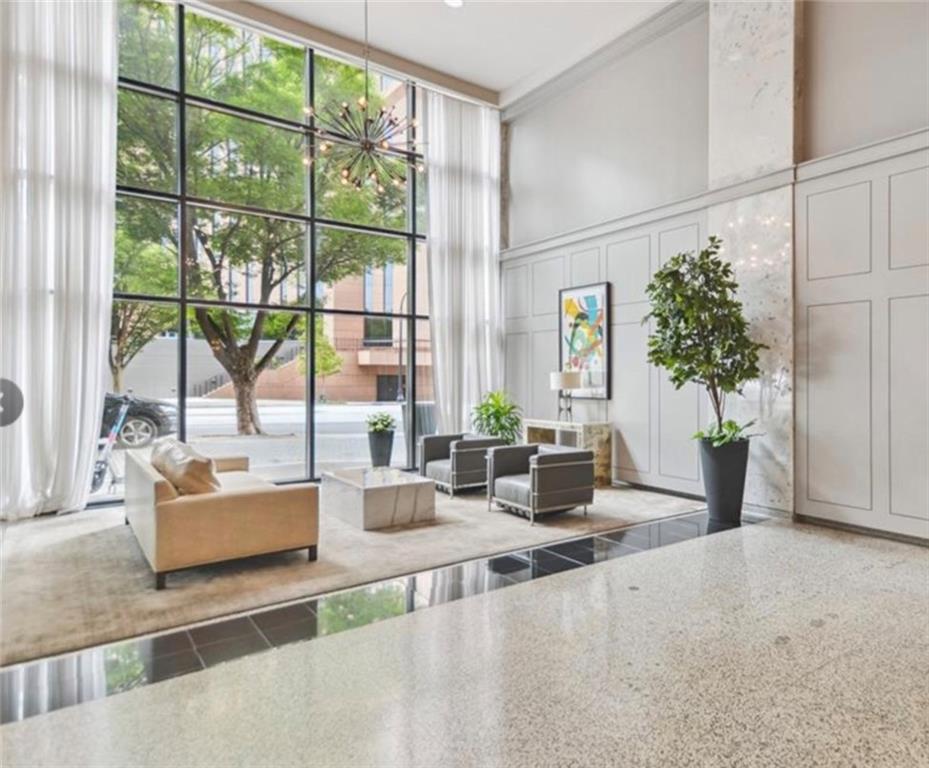 620 Peachtree Street Northeast, Unit 901 Atlanta, GA 30308 - Photo 3 of 19 a living room with furniture and large windows