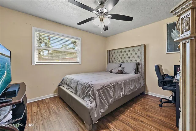 a bedroom with a bed a desk and chair