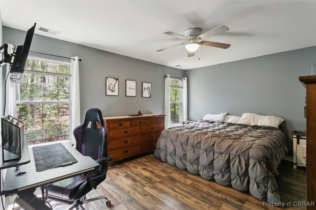 127 Low Ridge Road Williamsburg, VA 23185 - Photo 19 of 35 Bedroom featuring wood finished floors, ceiling fan, multiple windows, and visible vents