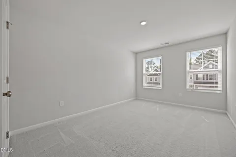 a view of an empty room with windows