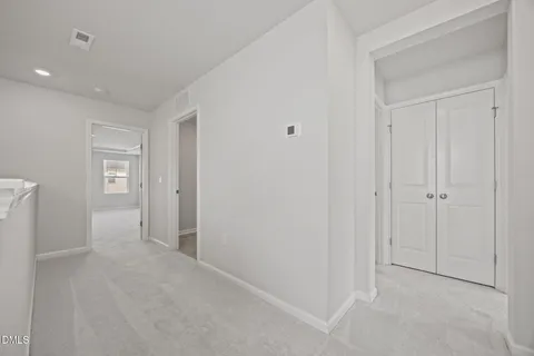 a view of an empty room and closet area